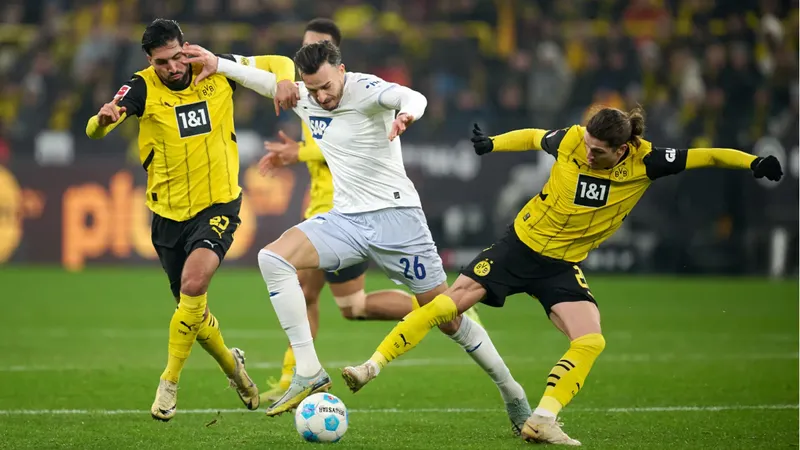 Cầu thủ Dortmund dùng kỹ thuật vượt qua cầu thủ Hoffenheim trên sân cỏ